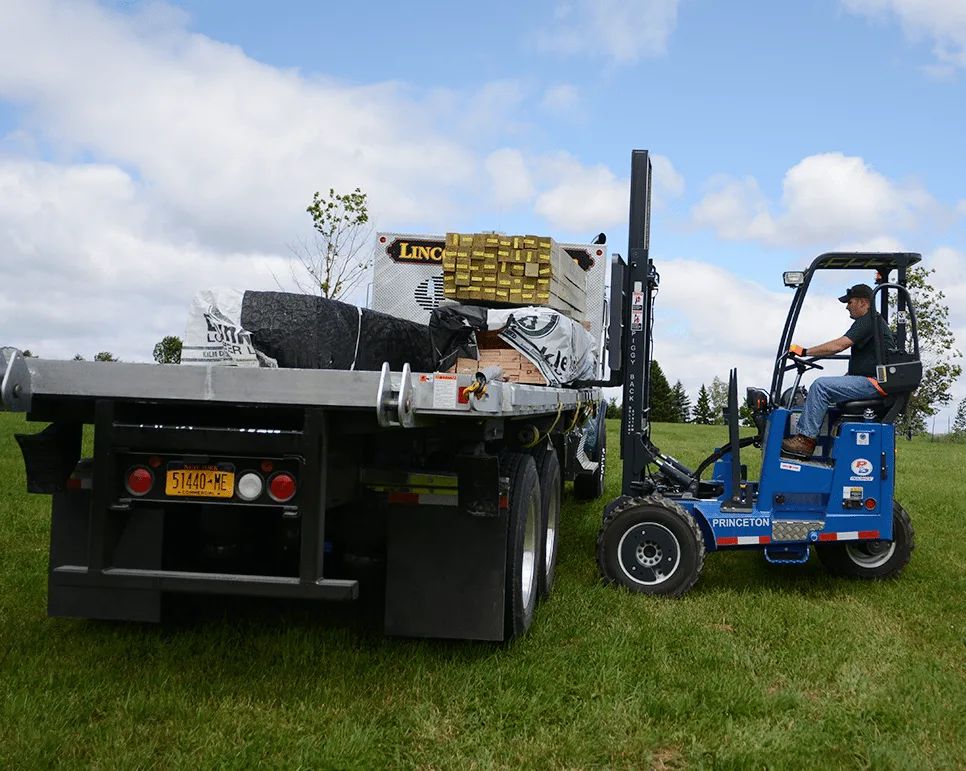 Photo of a male worker moving things off a Lincoln Davies truck.