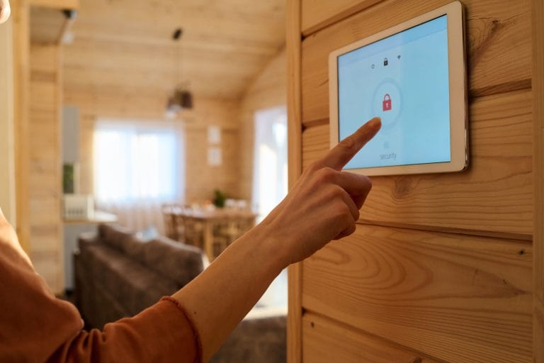 Photo of a woman's hand pointing to a screen that has a lock on it and says security.