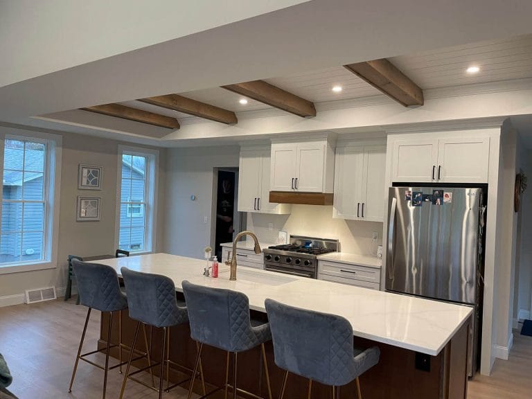 Modern kitchen featuring an island and bar stools.