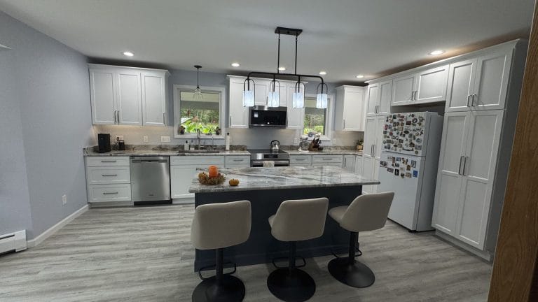 Modern kitchen with island and light fixtures.