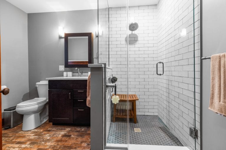 Modern bathroom featuring a glass shower and dark wood vanity