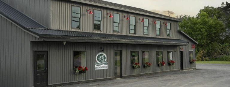 Lincoln Davies Design Showroom building with red lights and flower pots.